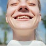 smiling woman with crooked teeth