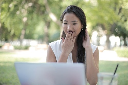 lady covers mouth with hand